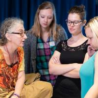 Prof. Libman discusses the script with four student actors in the rehearsal room